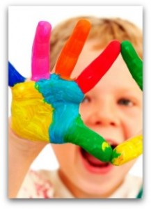 young kid with paint on his hands